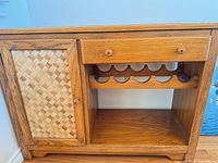 front view showing cabinet door, drawer, wine rack and shelf
