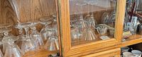 Cabinet shelf with multiple clear stemware pieces visible