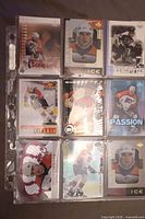 Front view of nine John LeClair trading cards in plastic sheet