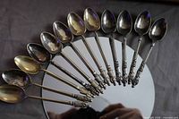 Fan layout of 12 monk-handled teaspoons