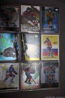 Front view nine Pavel Bure cards in plastic page