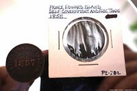 1855 token beside cardboard 2x2 holder marked PE-782