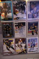 Page of nine Mario Lemieux hockey cards in plastic sheet