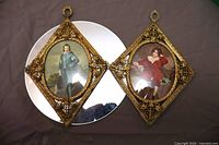 Both gilt framed prints side by side