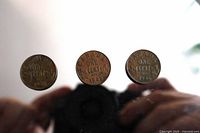 Overview of three Canadian one-cent coins dated 1920, 1932, 1936