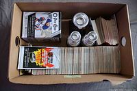 overview of box contents showing loose cards, sealed Pro Set pack, sealed O-Pee-Chee box, and three trophies