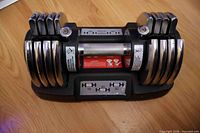 Top view showing full dumbbell in cradle with weight selector scale 10-20-30 lb