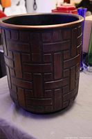 Front view of copper-tone planter showing geometric pattern