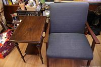 side table beside upholstered armchair