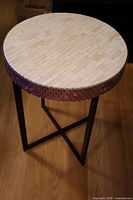 Full view of round accent table showing tiled top, copper hexagon sides, and metal base
