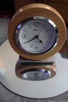 Front angled view of Premier wood desk clock and mirrored surface reflection