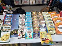 Table view showing stacks of Bathroom Reader, Play Piano, Christmas and slow cooker cookbooks