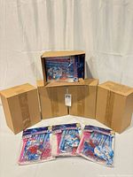 Stacks of shipping boxes with three visible sealed Cinderella favor packs