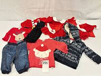 Group shot showing all eight baby clothing items spread out
