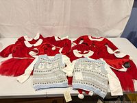 Overview of all eight outfits laid on table