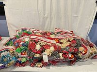 Pile of sealed 40-count gift bow bags with variety of colors