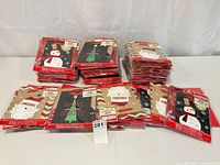 Stack of sealed gift bag packages on table