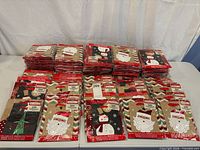 Stacks of sealed 2-pack Christmas gift bags showing assorted designs