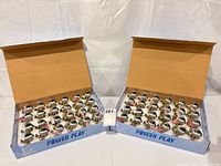 Two open boxes showing all 48 packaged snowman ornaments