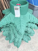 Stack of green star-shaped Christmas tree stands