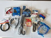 Overview of all packaged cables, WD My Passport drive, banana plugs on table