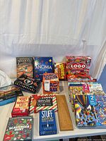 Group shot of all game and puzzle boxes plus cribbage board