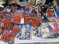 Table with multiple Pumpkin Masters kits, packaged children’s costumes, glitter headbands