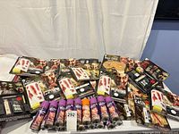 Table view showing multiple unopened Halloween makeup kits and hair spray cans