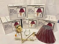 Five boxed Gen-Lite lamps and one unboxed showing components and shade