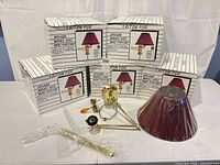 Five sealed boxes plus one lamp assembly and shade displayed, showing full lot contents