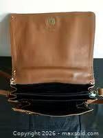Interior view with flap open showing compartments and lining