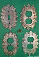 Front view of all four ornate covers plus screws