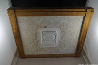 Back view showing plaster panel within wood frame and central recessed area