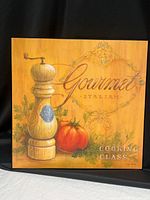 Full view of square wood plaque with still life imagery and text