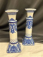 Front view of both candlestick holders showing overall design and condition