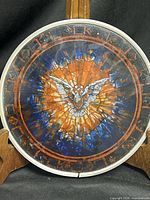 Full view of circular stained glass suncatcher on wood stand