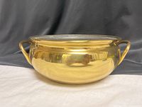 Front view of brass double-handled bowl