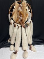 Full view of dreamcatcher showing fur, feathers and wool tails
