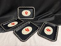 All four trays displayed on black fabric