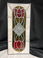 Full view of stained glass panel showing entire design and hanging chain