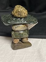Front view of stacked stone inukshuk sculpture with tag attached