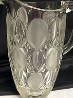 Front view of pitcher showing clear and frosted oval pattern and handle