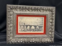 Full view of framed etching in ornate carved frame