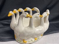 angled front view showing eight white geese forming planter ring
