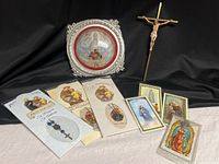 Lot overview displaying crucifix, round framed art, four medal prayer cards and three holy cards