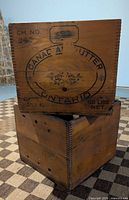 Both butter boxes stacked showing dovetail joints and stencilling