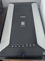 Top view of Canon CanoScan 5600F scanner showing control buttons and branding