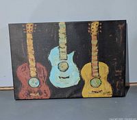 Front view of the entire stretched canvas print with three guitars