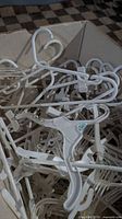 Box view of assorted white and clear child hangers