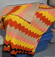 Afghan draped over bin showing overall size and colour pattern